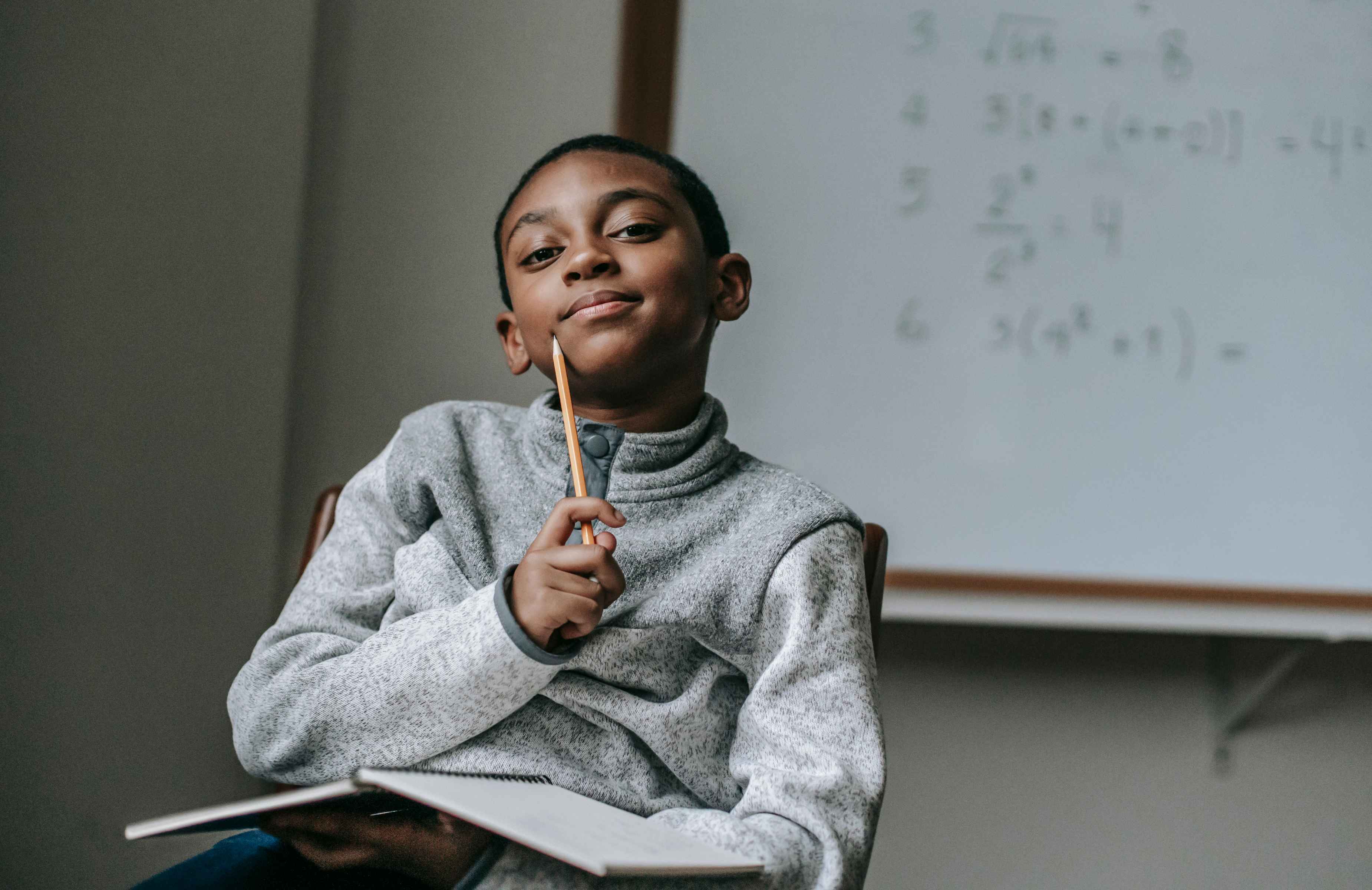 Thoughtful boy with pencil